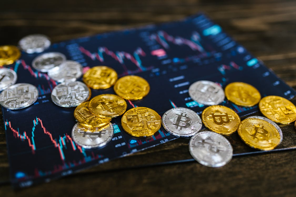 A group of coins on a blue and red graph

AI-generated content may be incorrect.